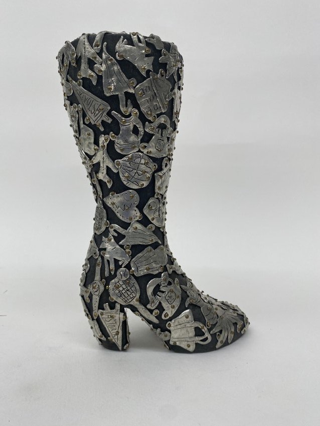 A high heeled boot with milagros from the Female Fetish series by Claudia DeMonte